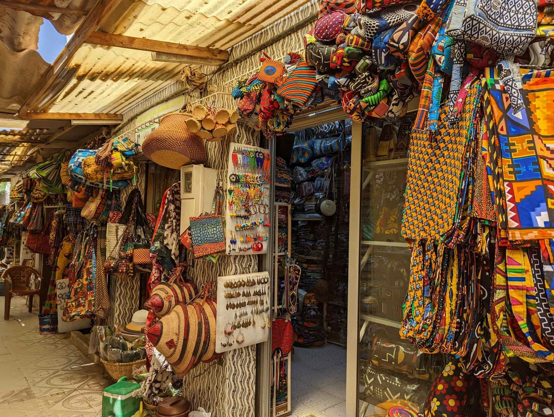Shop displaying colorful bags and textiles, exterior shot.