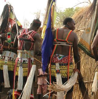 People in colorful beaded attire, possibly ceremonial.