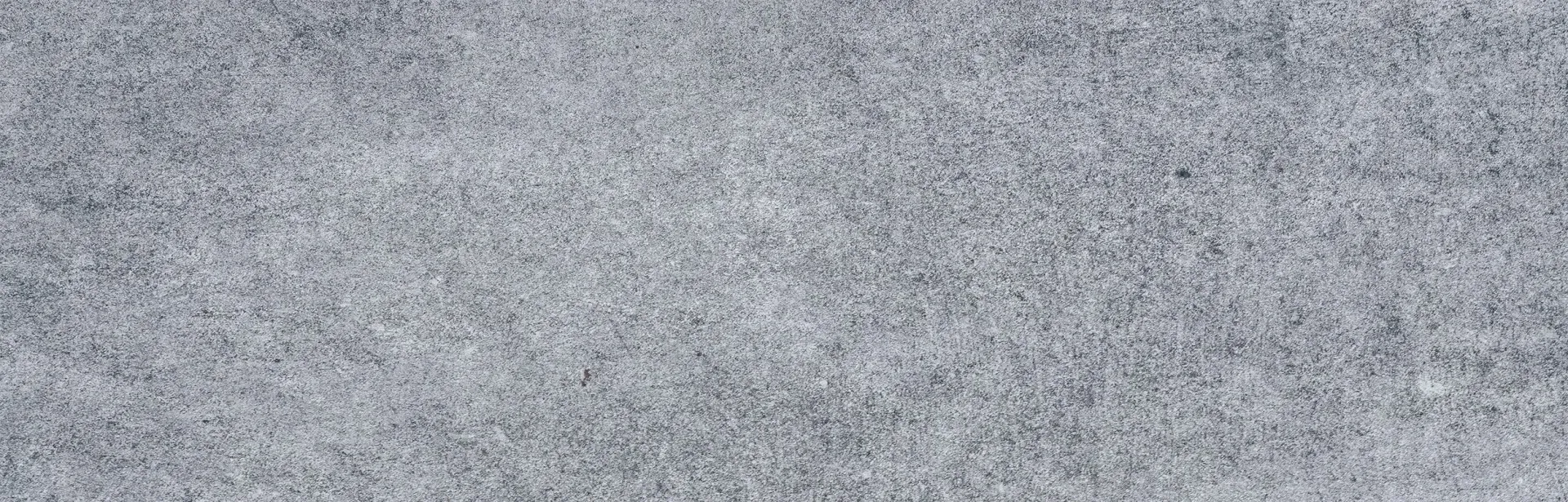 Close-up view of a textured, light-gray surface.