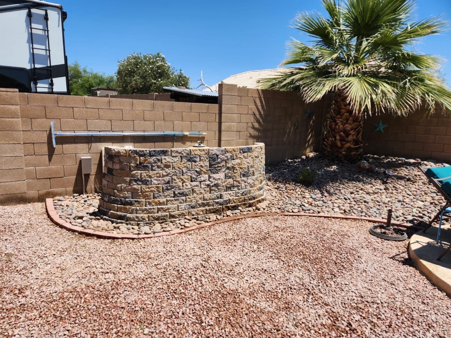 Natural stone steps bordered by a stunning retaining wall, planter, and garden border.