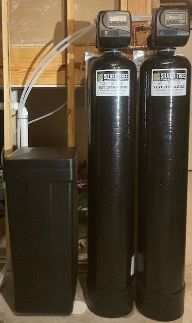 A row of water filters are lined up in a room.