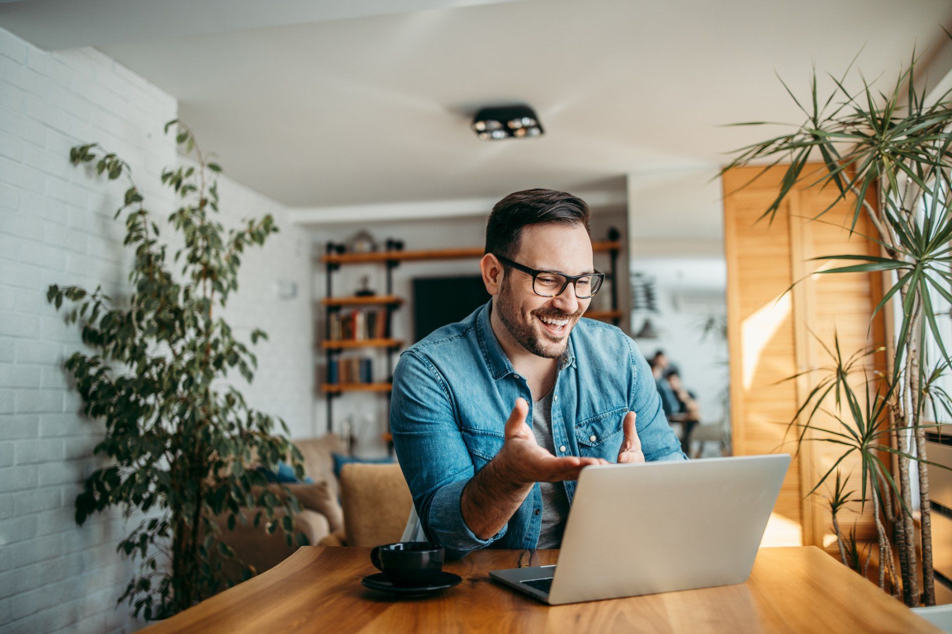 Cheerful Man Having Video Call On Laptop — Indianapolis, IN — Intecare