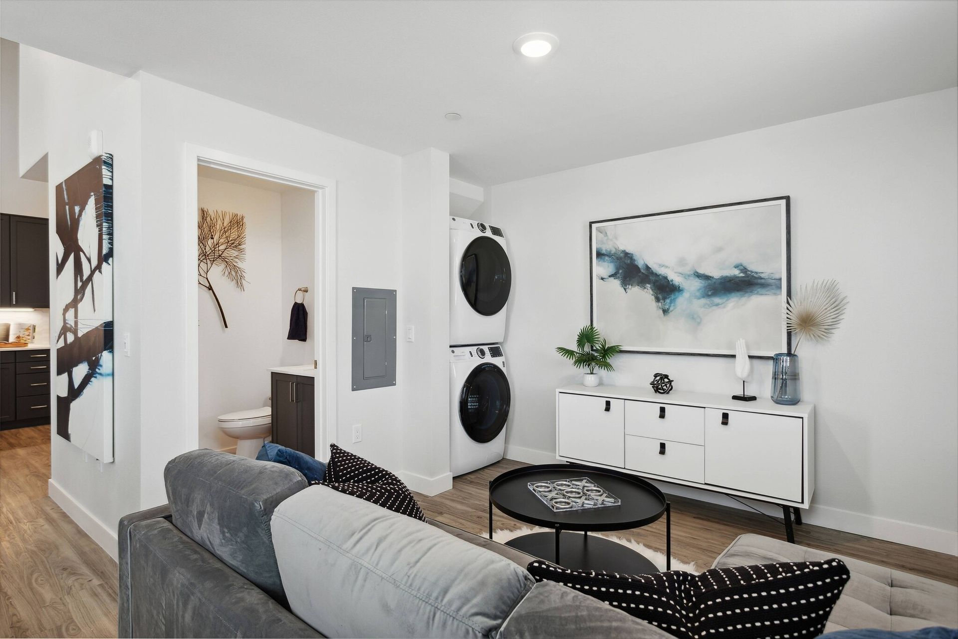 Living room with modern features and in-unit washer and dryer at Maven on Broadway.