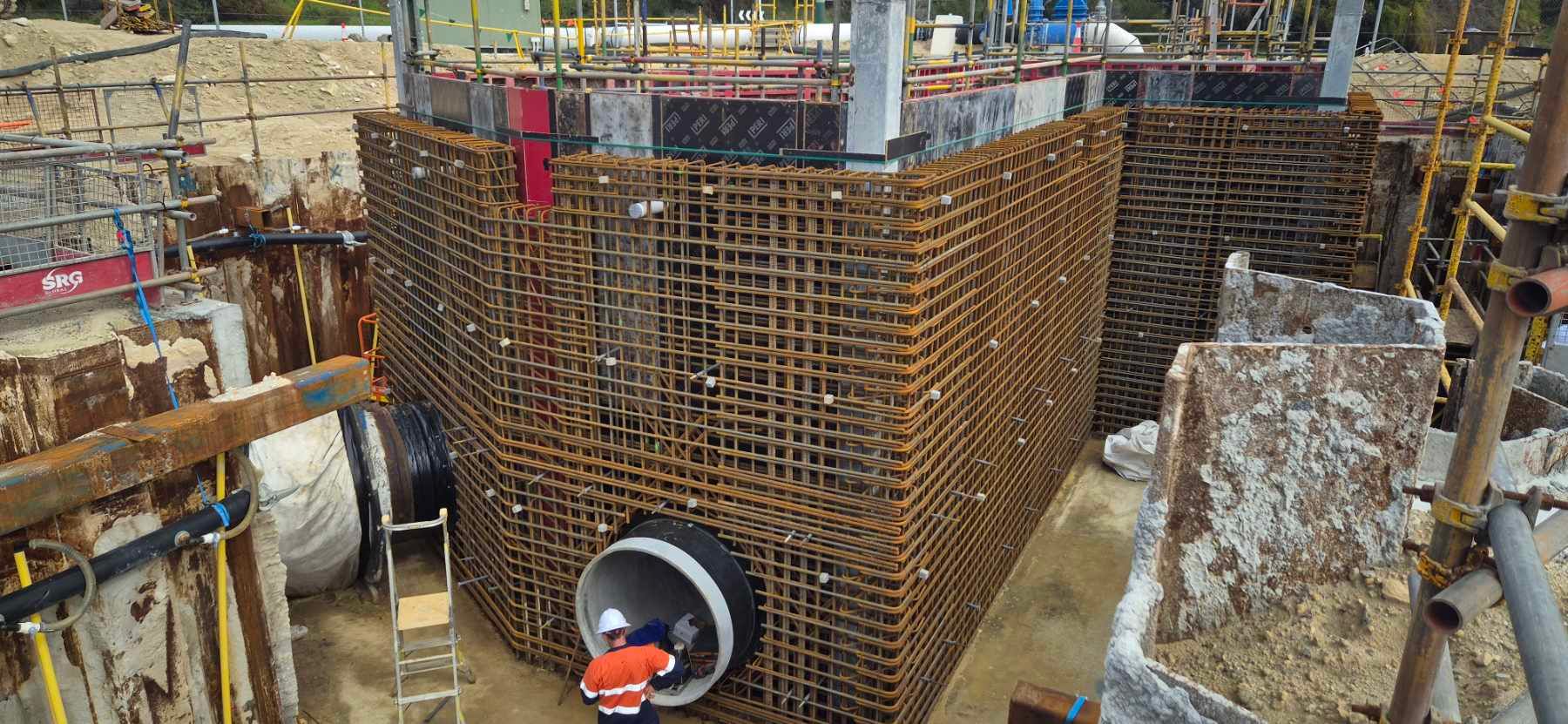 A group of construction workers are working on a large metal structure.