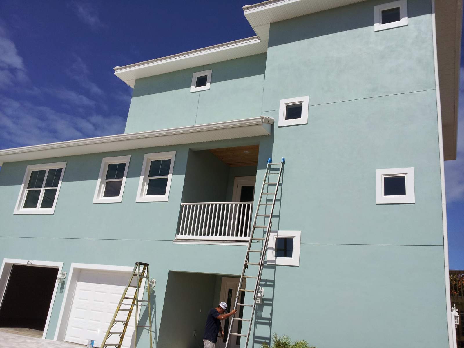 Front View of a Building With Ladders On It — Vero Beach, FL — Bucio Painting Inc.