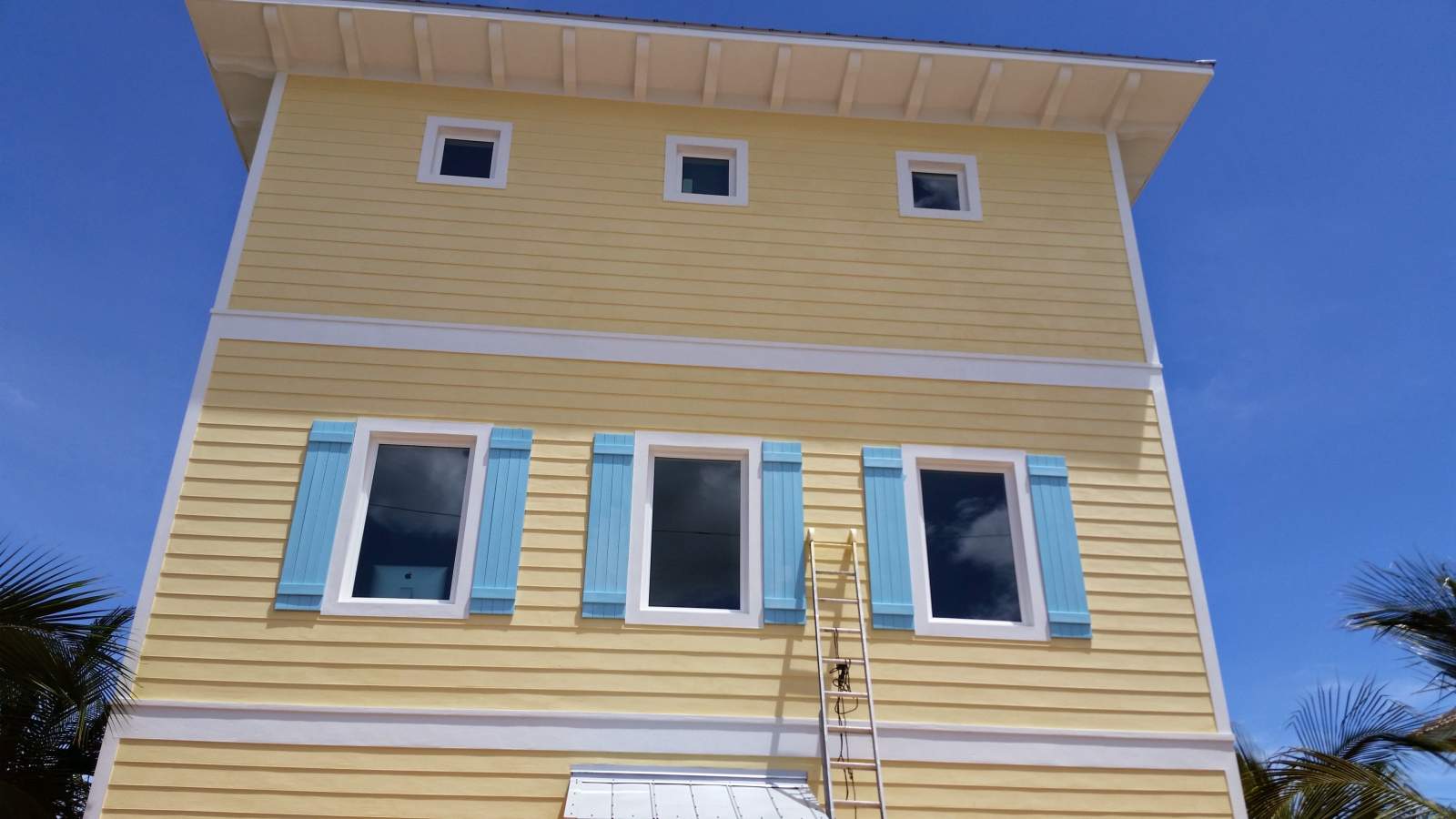 Orange Building With Blue Window Sills — Vero Beach, FL — Bucio Painting Inc.
