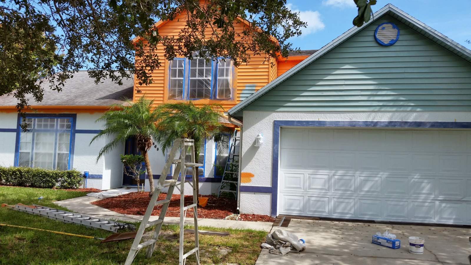 Outdoor View of a Home Being Painted in Orange — Vero Beach, FL — Bucio Painting Inc.