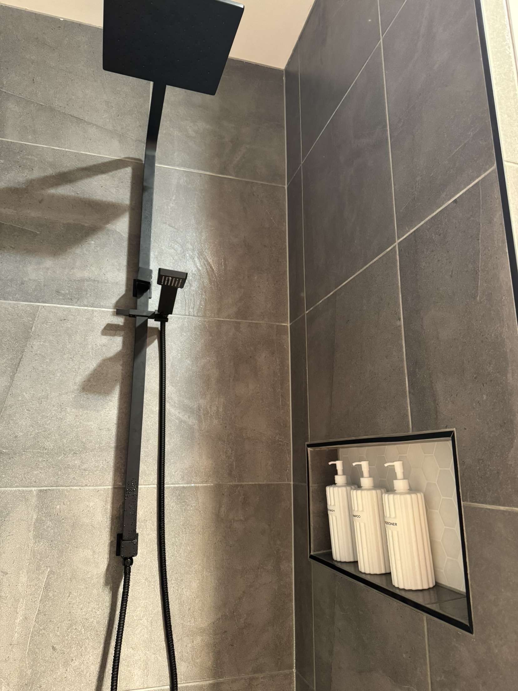 Black Shower Fixtures in a Grey-tiled Shower — The Wright Way Building In North Albury, NSW