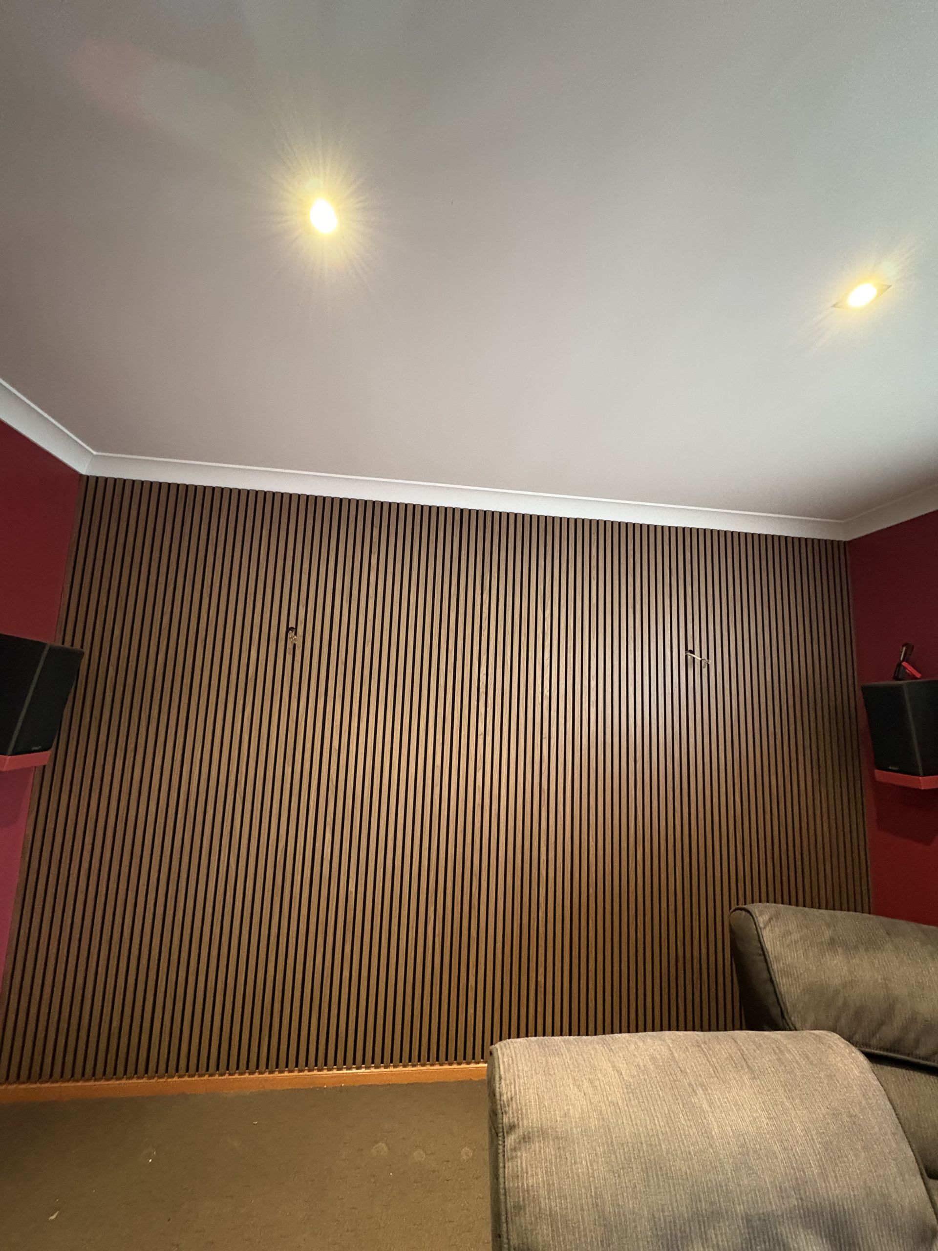 A wall with brown patterned wallpaper in a room with a sofa and red side walls — The Wright Way Building In North Albury, NSW