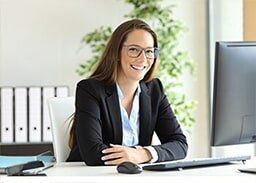 Smiling woman at work — Business Insurance in Merrillville, IN