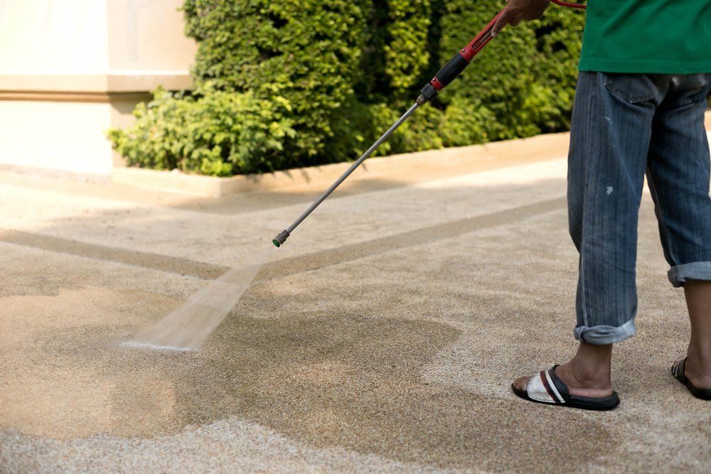 Man pressure washing his driveway