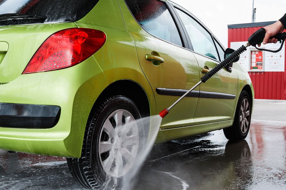 pressure washing green car's tire