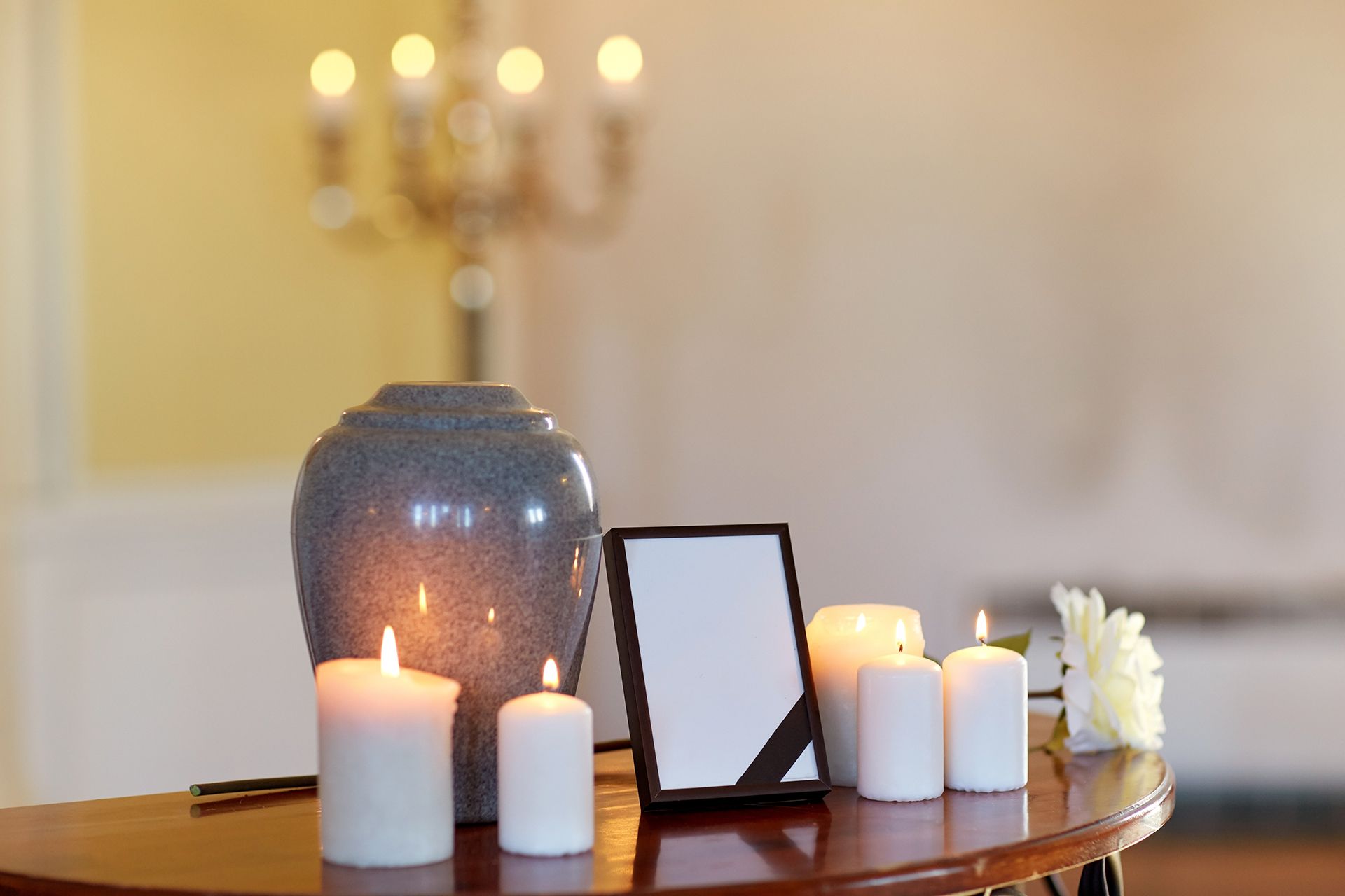urn with candles and photo frame