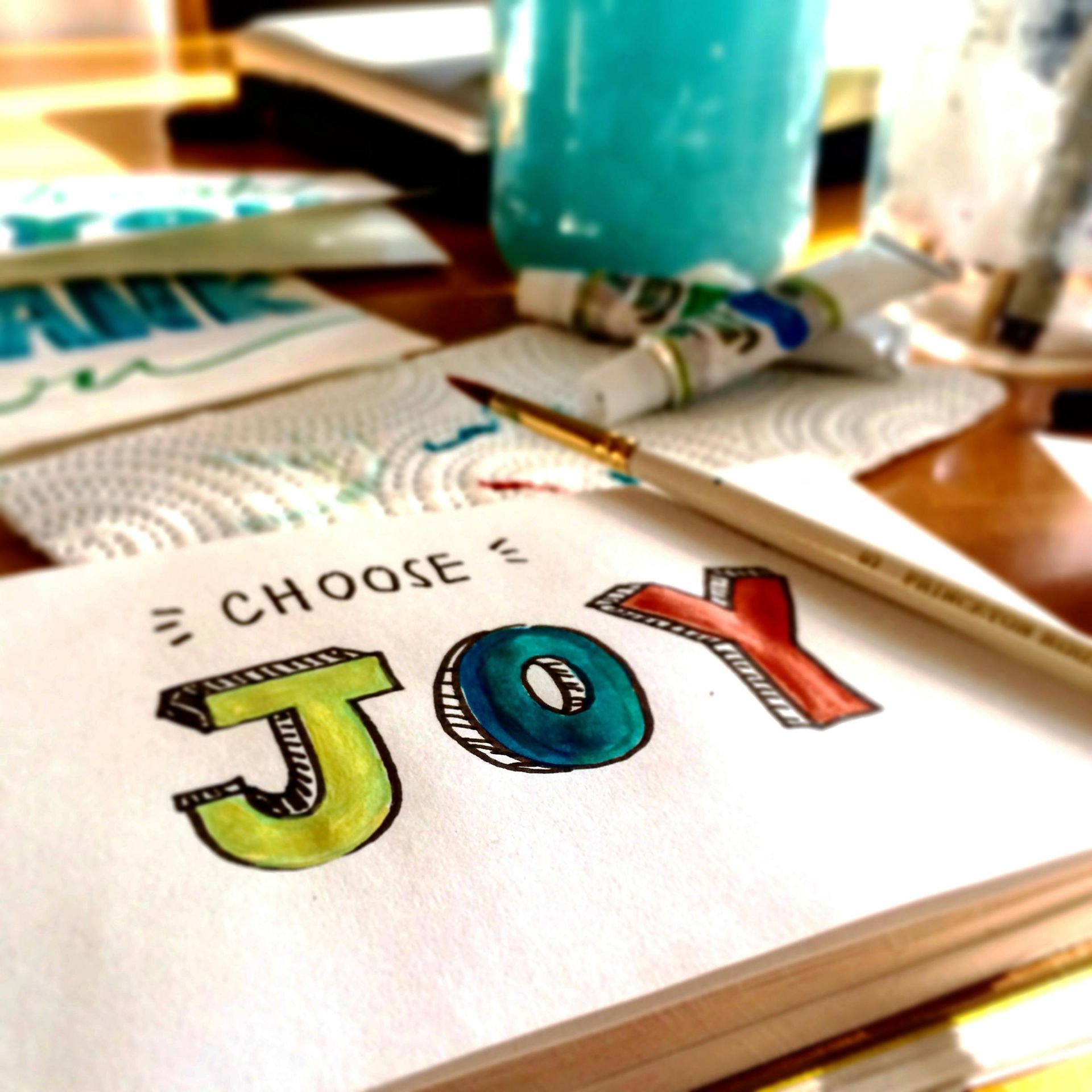 A piece of paper that says choose joy on it