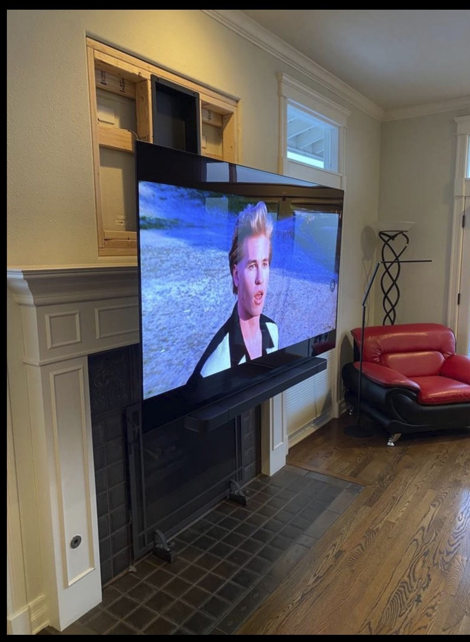 A living room with a fireplace and a flat screen tv