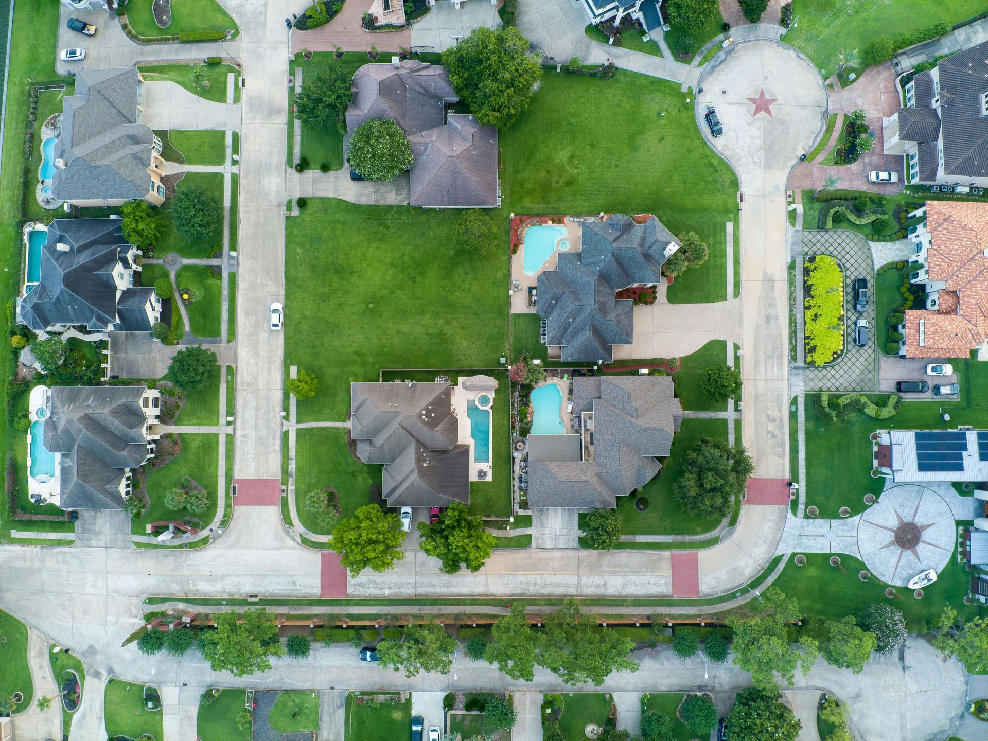 An aerial view of a residential neighborhood with lots of houses and trees.