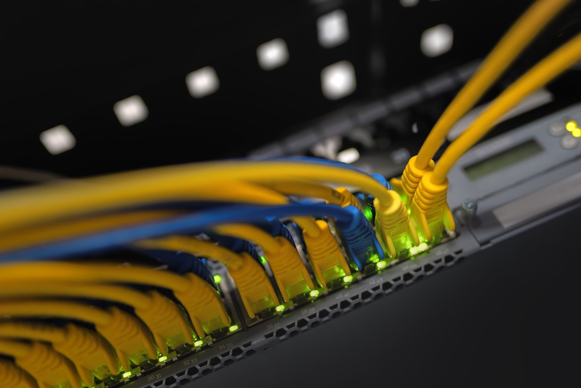 A bunch of ethernet cables are connected to a server.