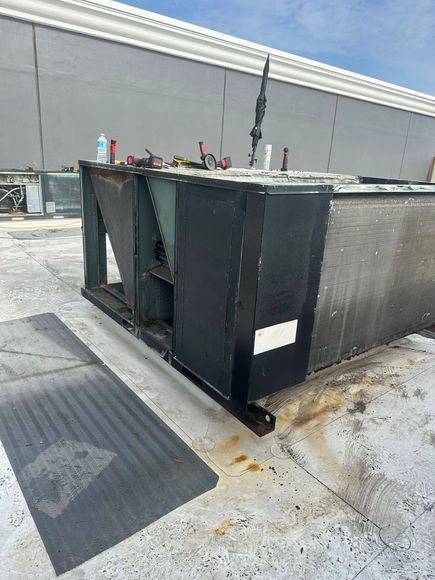 A large black box is sitting on the roof of a building.