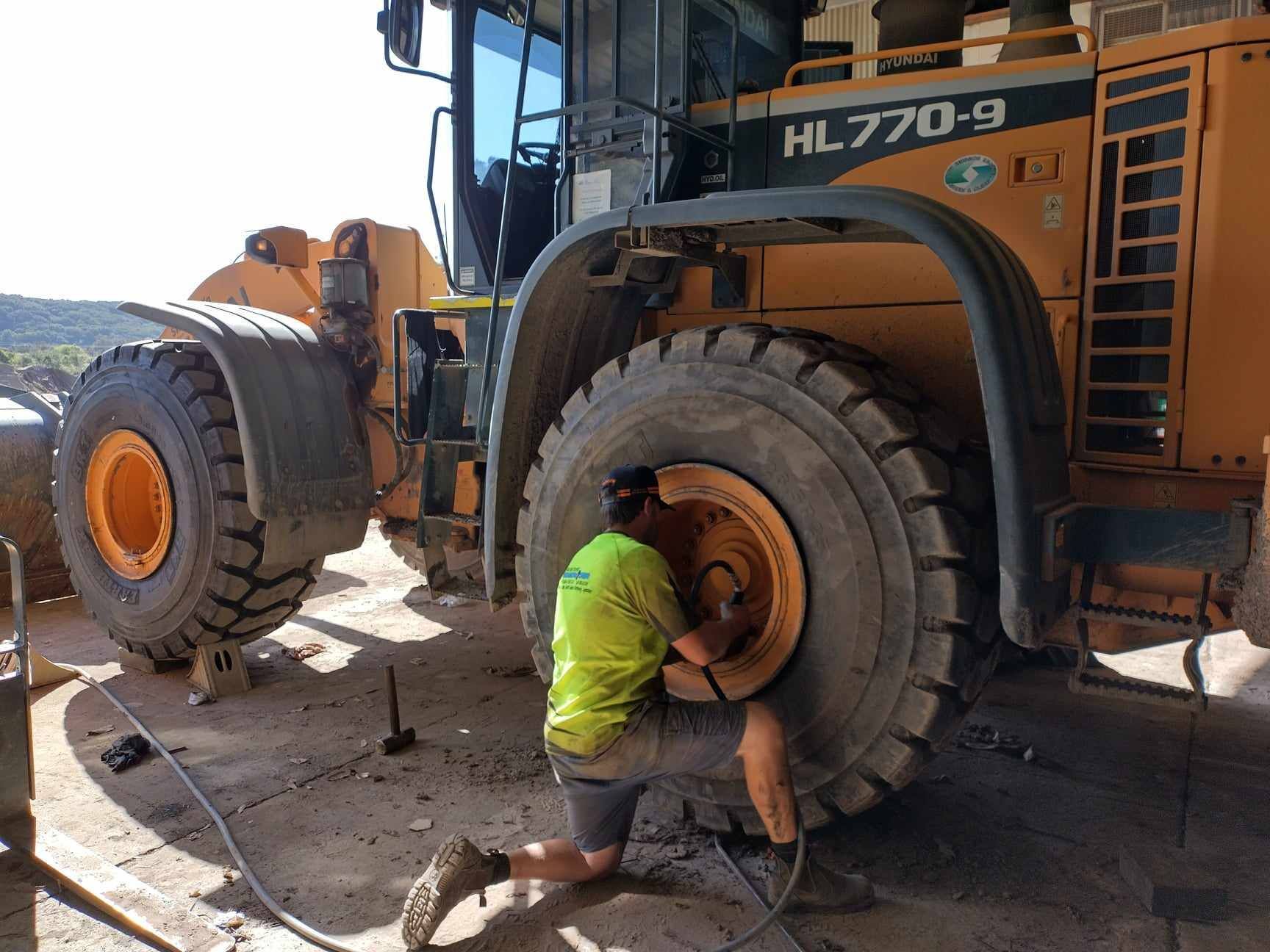 Industrial Machinery Tyre Being Replaced — Tyres in Murwillumbah, NSW