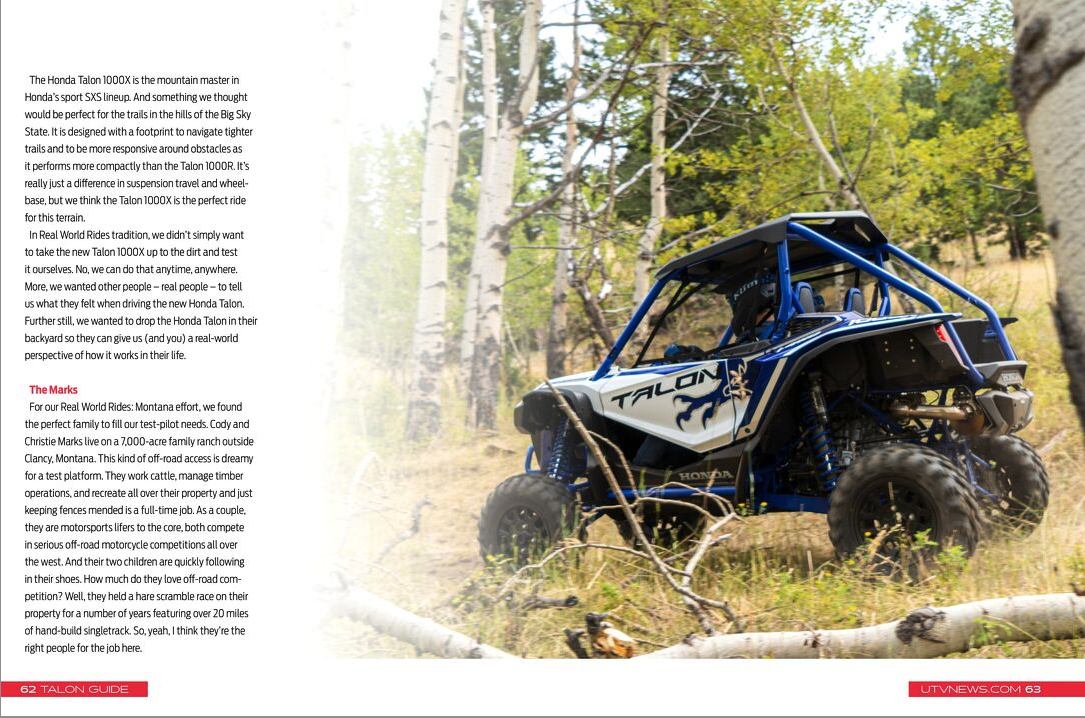 a blue and black atv is parked in a field next to a tree .