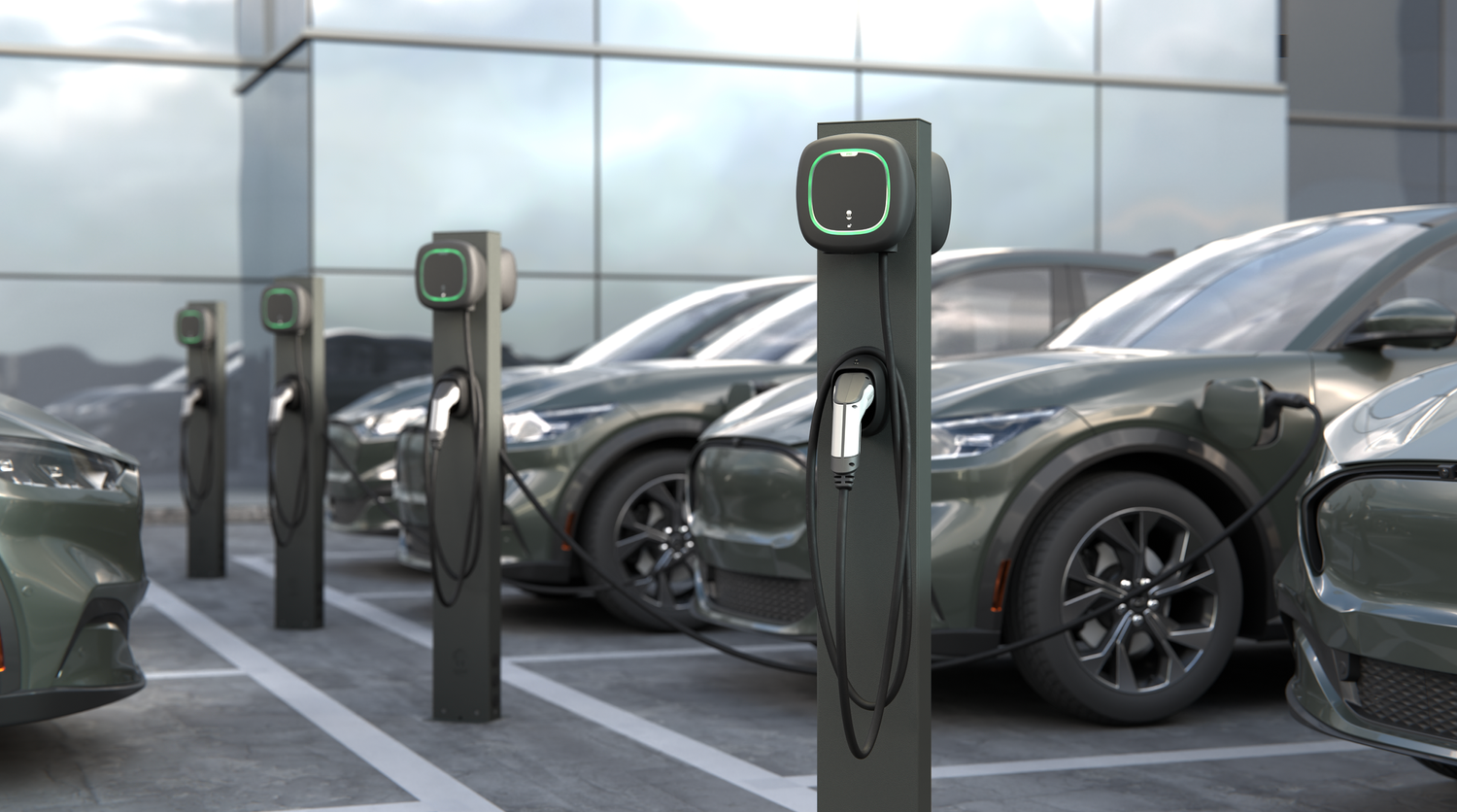 A row of electric cars are being charged at a charging station.