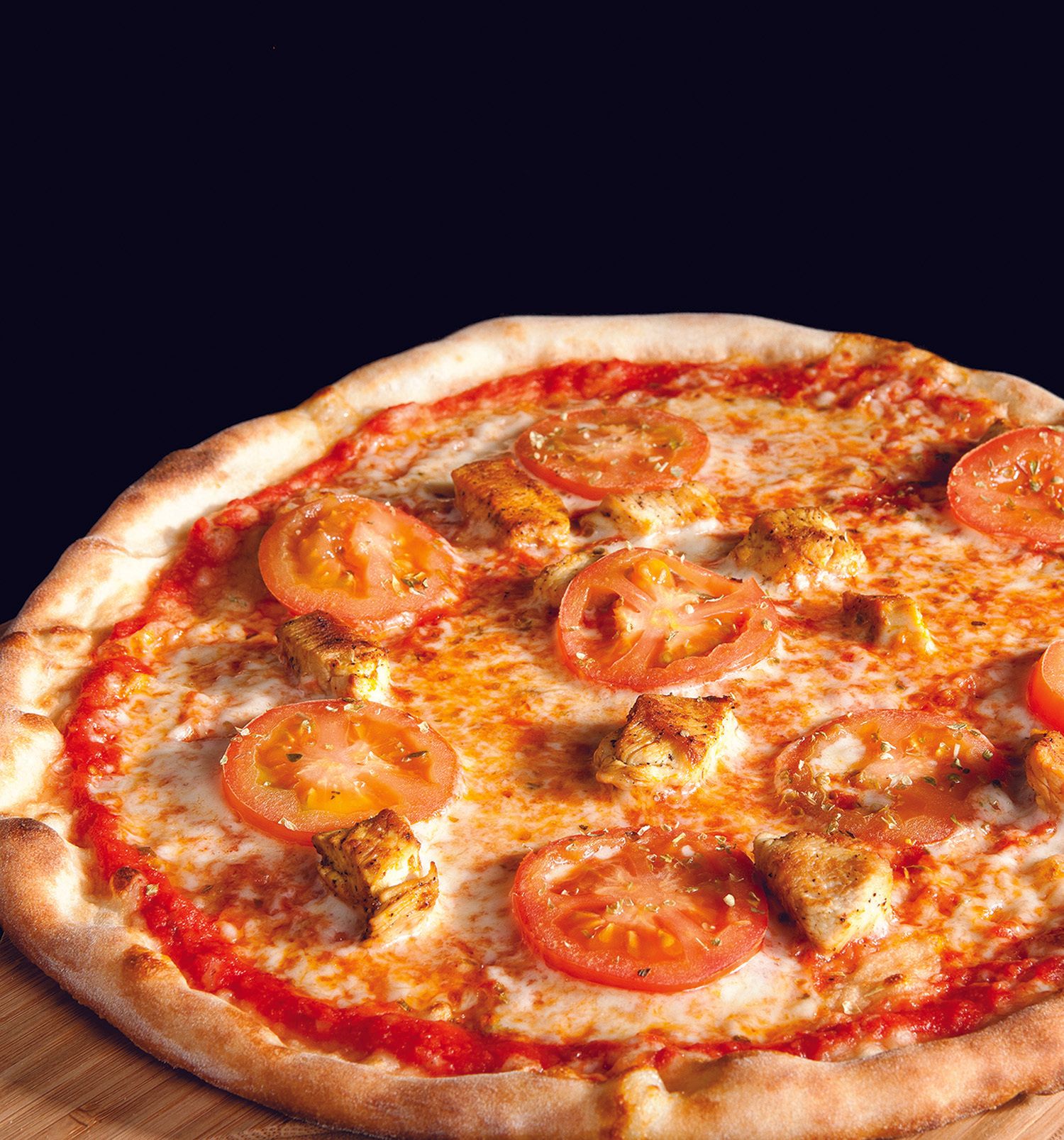 A pizza with tomatoes and cheese on it