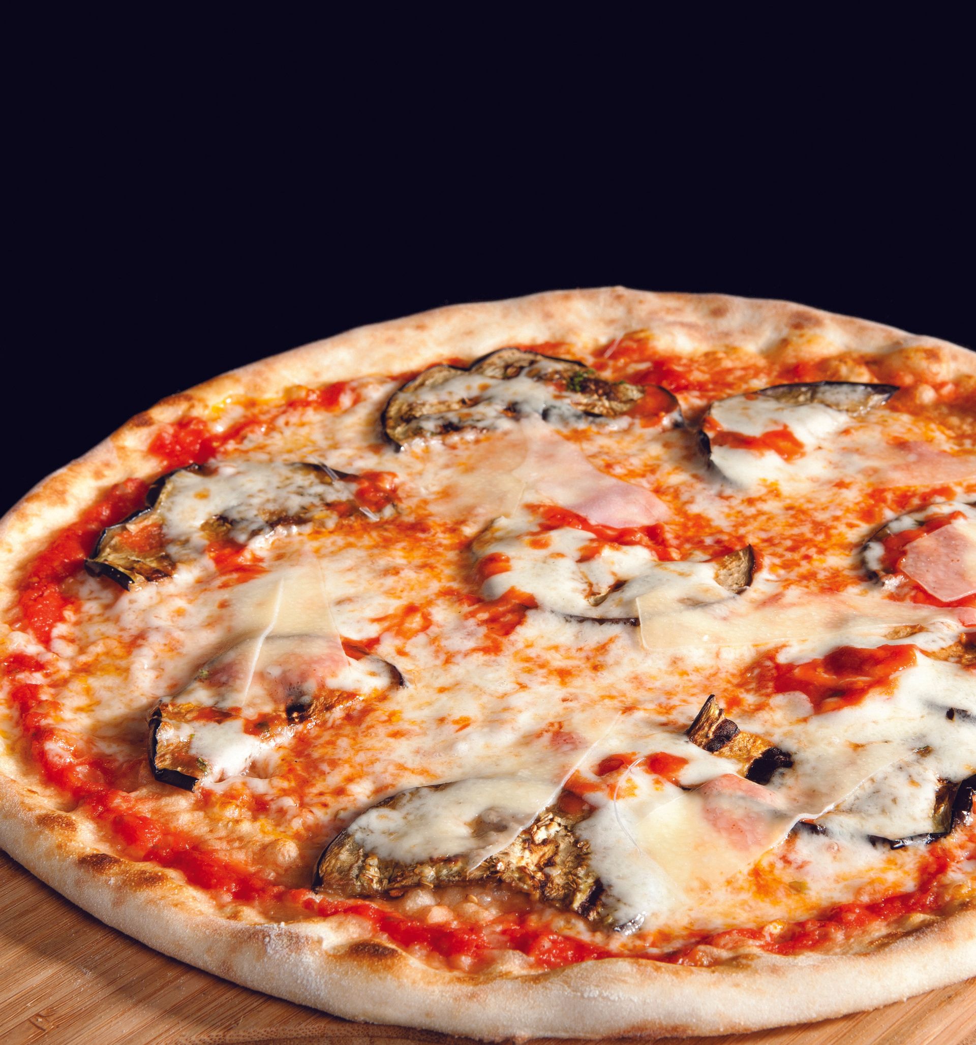 A pizza with eggplant and cheese on it