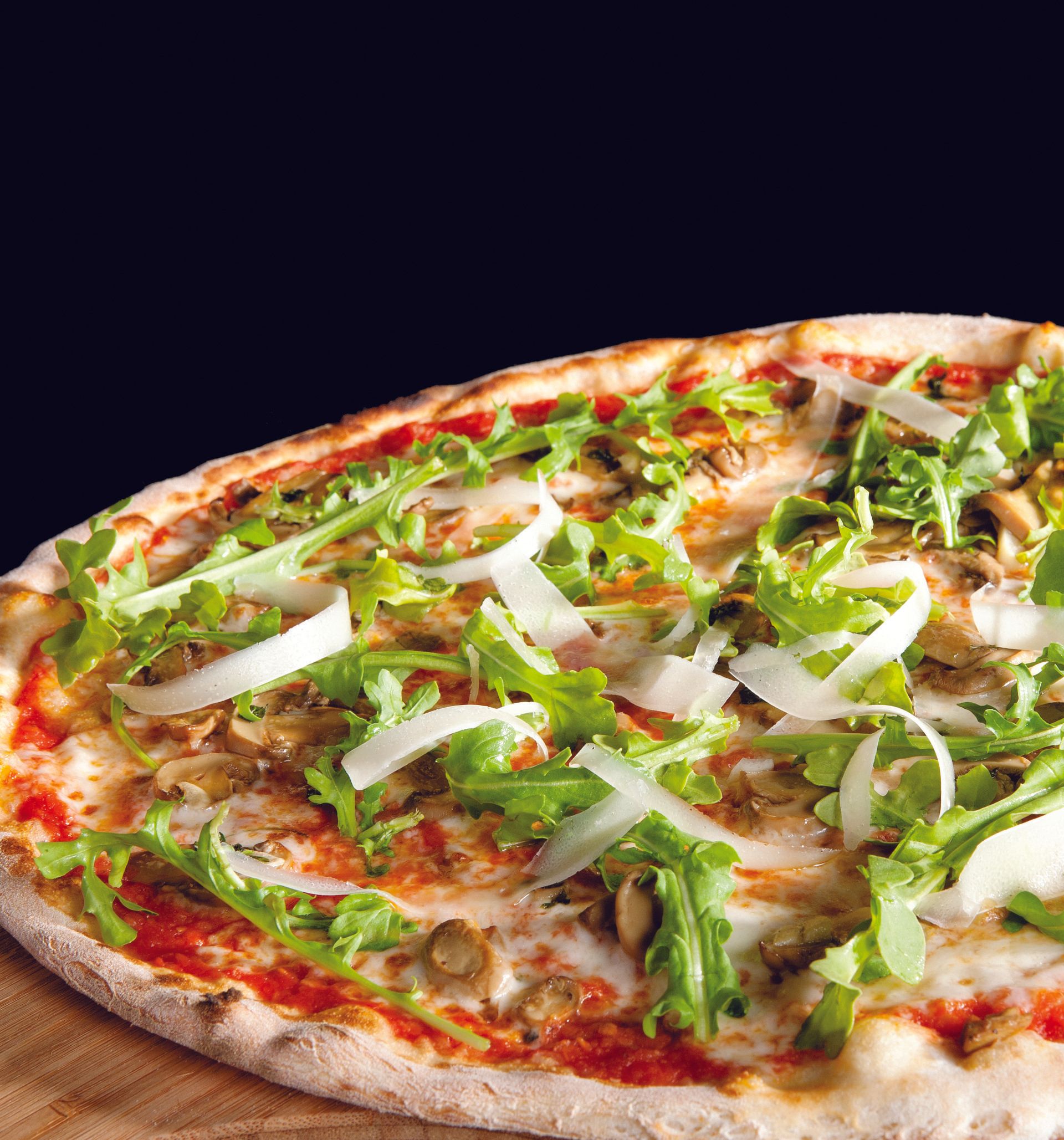 A pizza with lettuce mushrooms and cheese on it