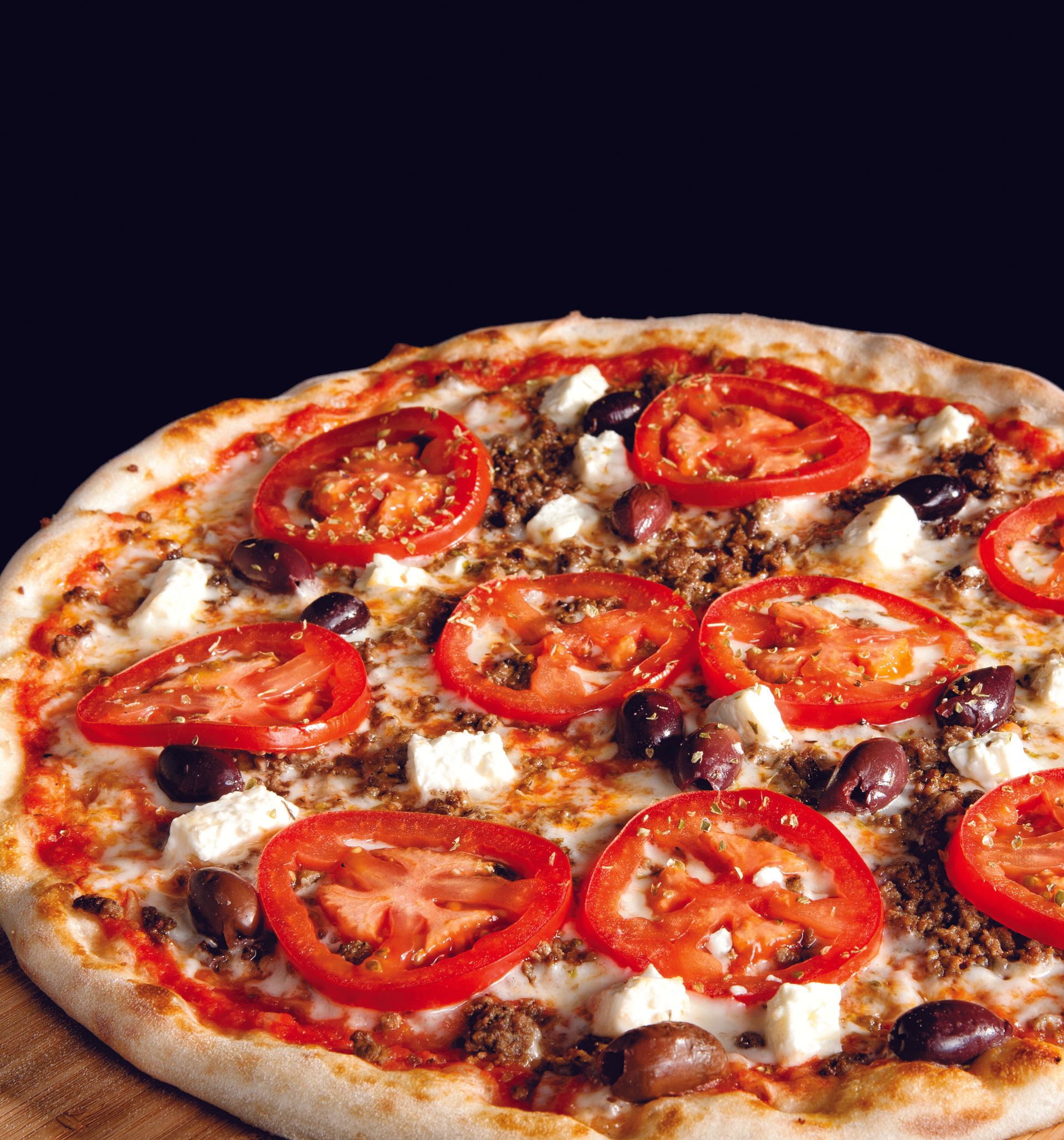 A pizza with tomatoes olives and cheese on it