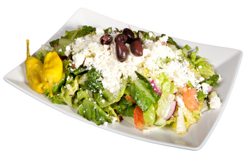 A white plate topped with a salad and a pepper