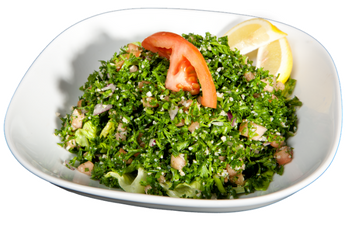 A salad with tomatoes and lemon on a white plate