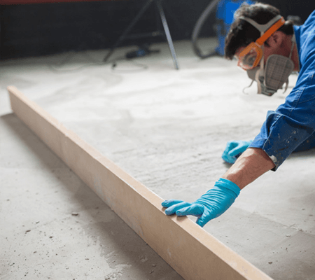 Worker checking the level of the concrete floor