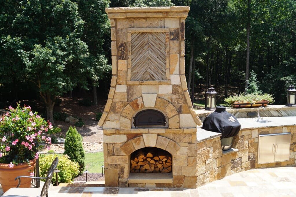 A stone fireplace with a pizza oven inside of it