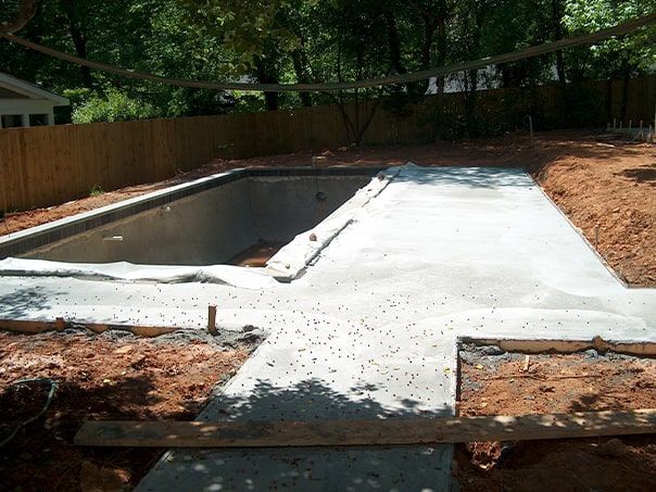 A large swimming pool is being built in a backyard