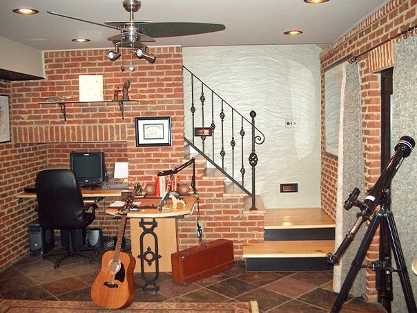 A room with a guitar and a telescope in it