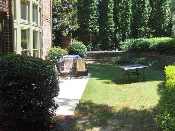 A lawn with a table and chairs in it