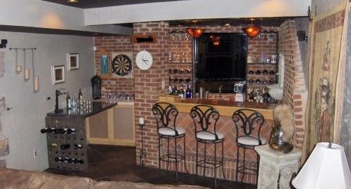 A custom built brick masonry bar and  brick walls and stone slate flooring.