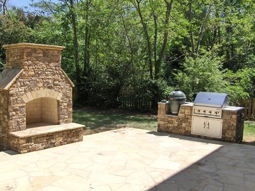 There is a fireplace and a grill in the backyard.