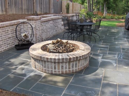 There is a brick fire pit in the middle of the Pennsylvania Bluestone patio.