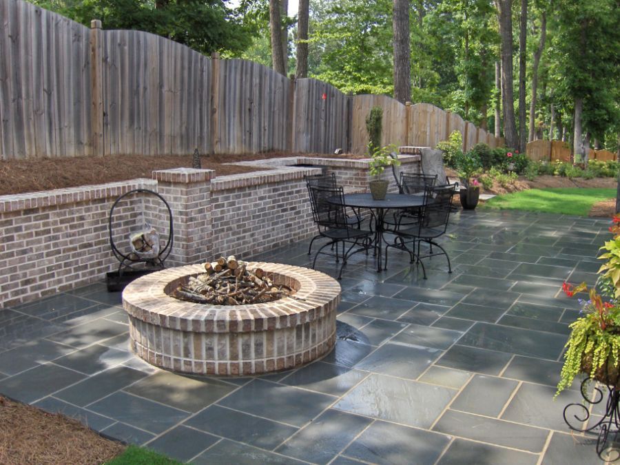 There is a fire pit in the middle of the patio.