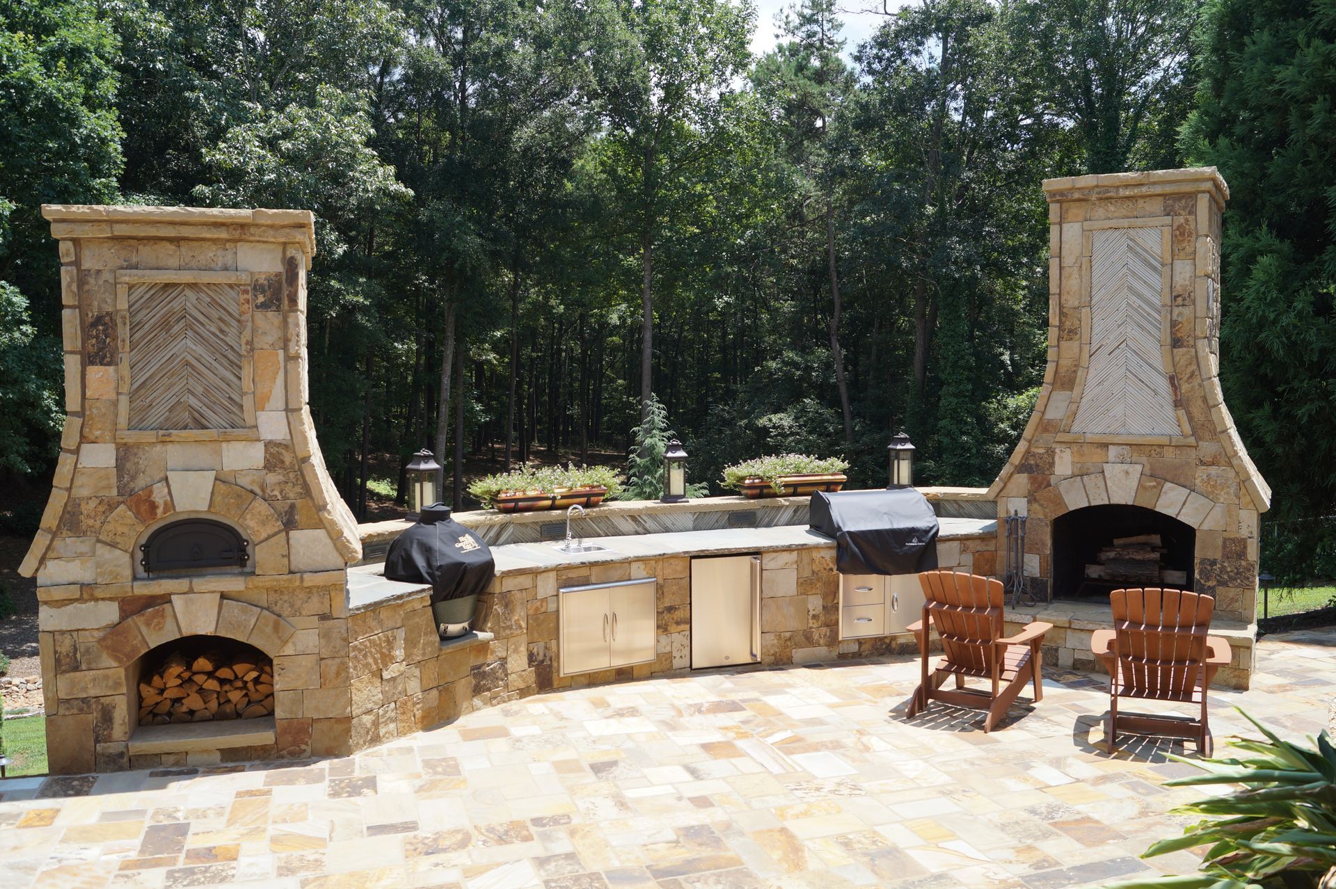 A patio with a pizza oven and a fireplace