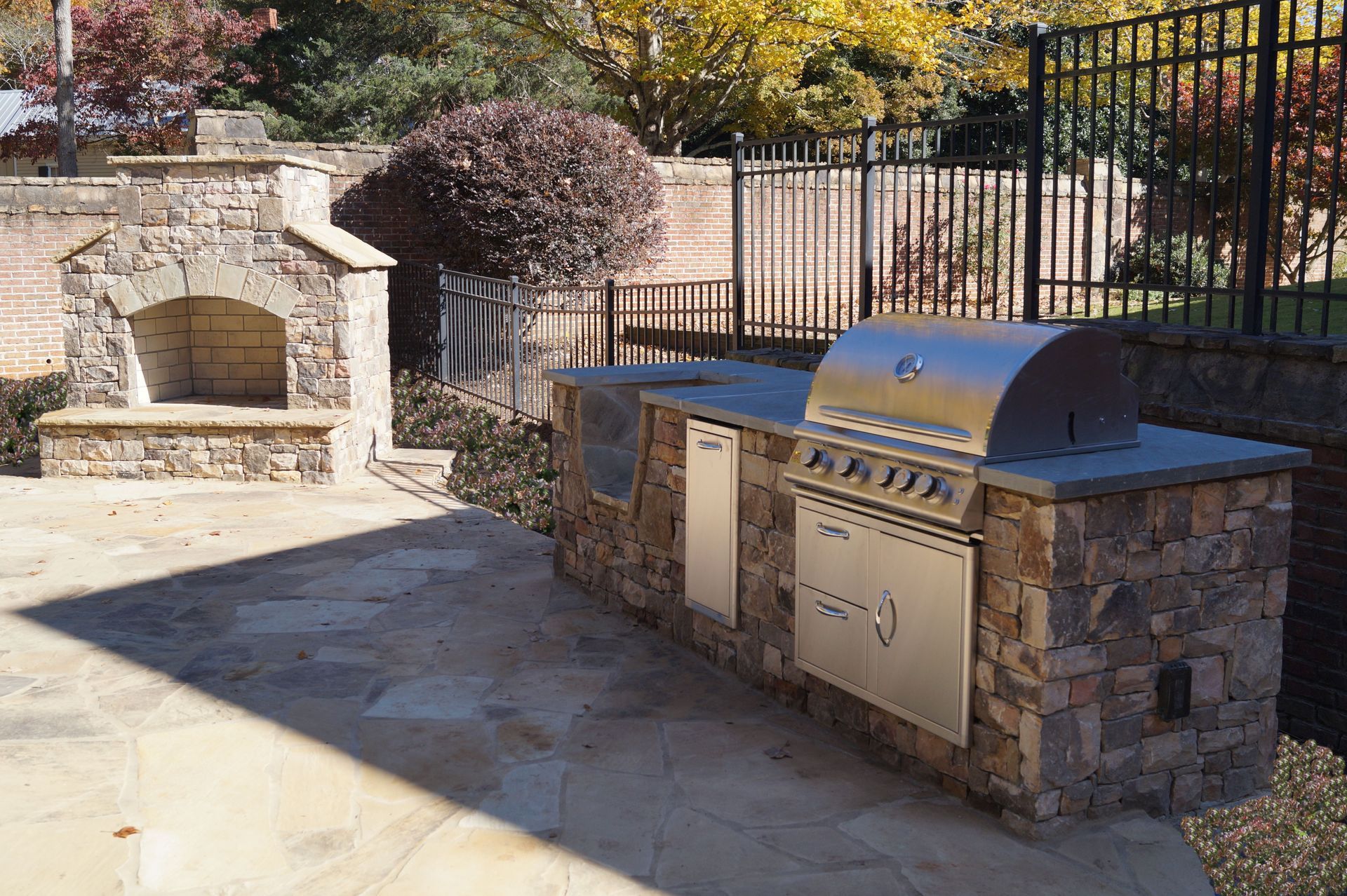 There is a grill and a fireplace in the backyard.