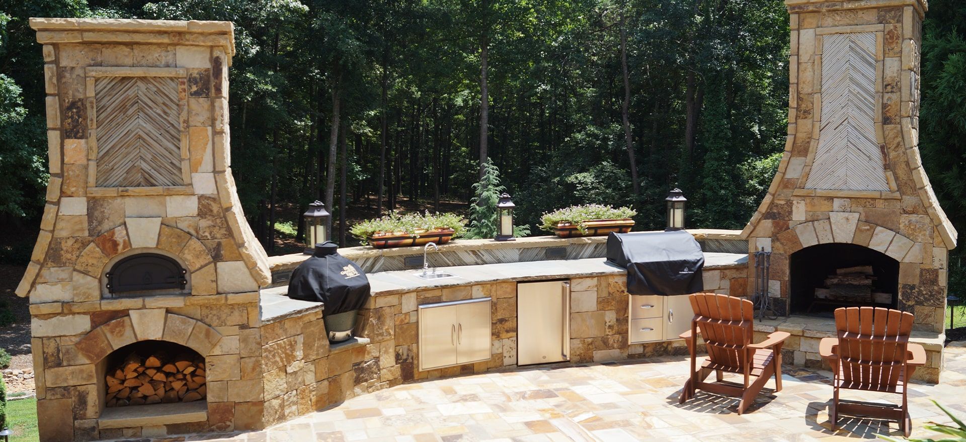 A patio with a pizza oven and a fireplace