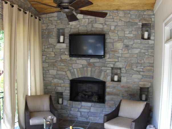 A living room with a fireplace and a flat screen tv
