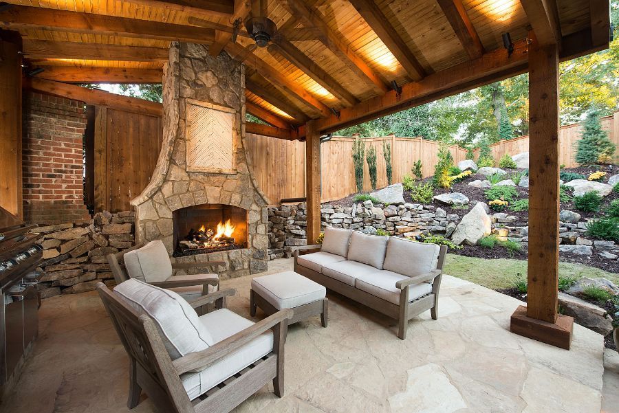 There is a fireplace in the middle of the patio.