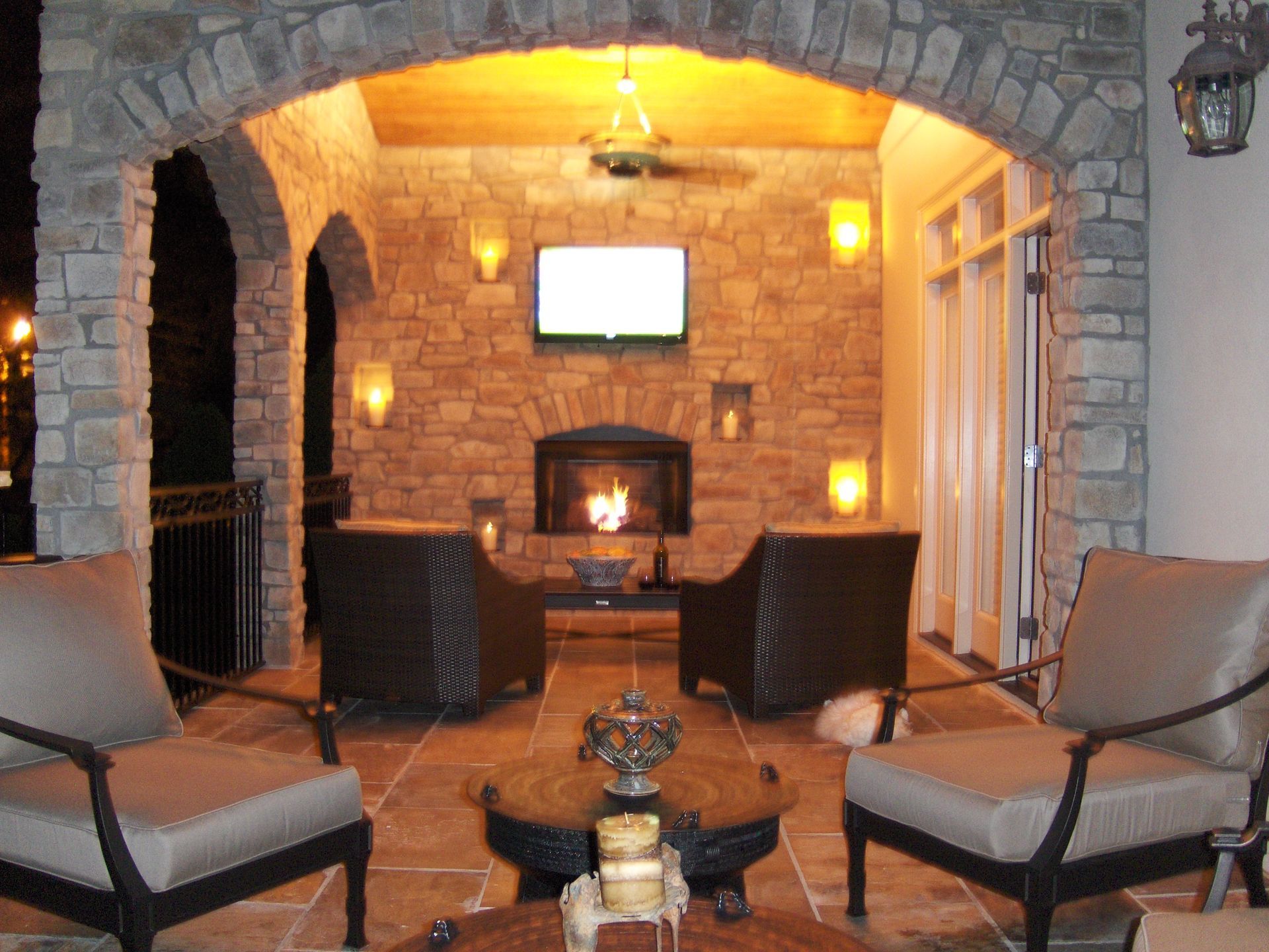 A patio area with chairs and a fireplace