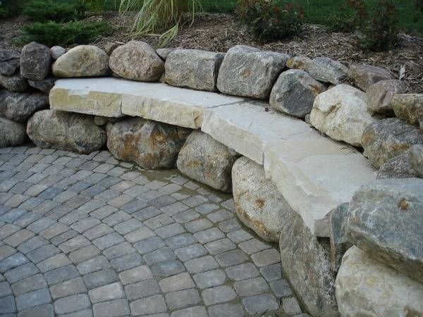 A stone wall with a bench built into it
