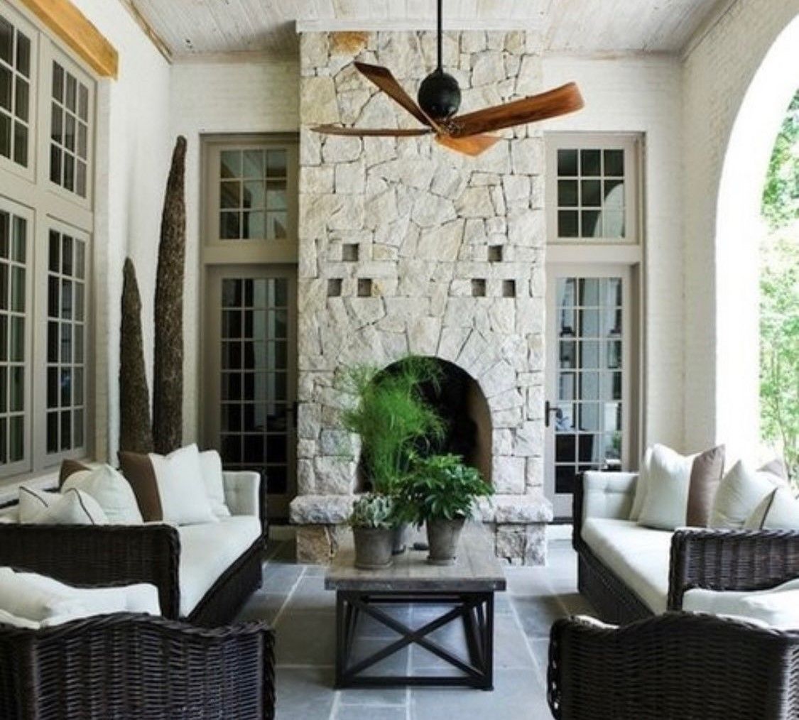 An outdoor living room with a PA Bluestone patio and a limestone fireplace.