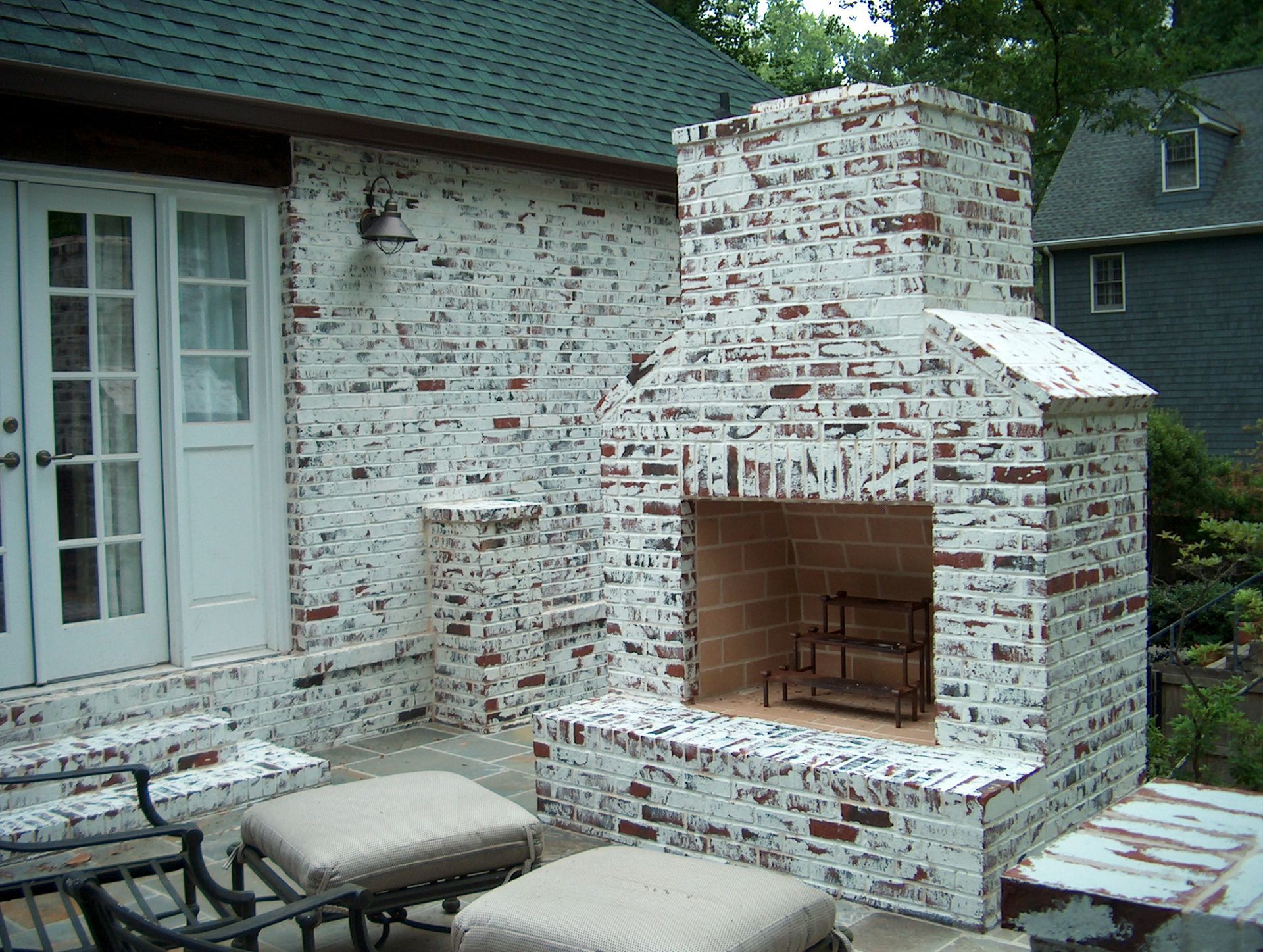 A brick fireplace is built into the side of a house