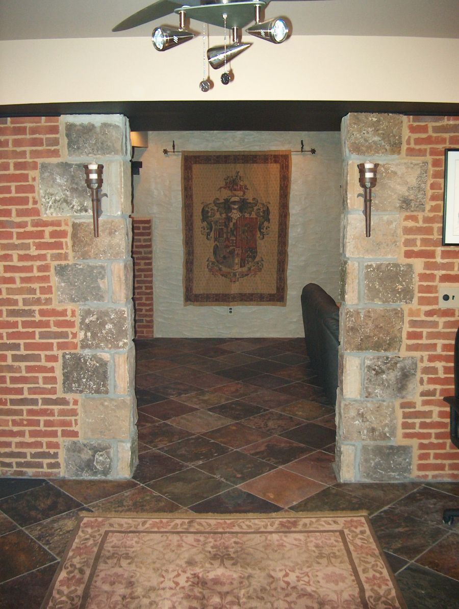 A room with brick walls and a rug on the floor